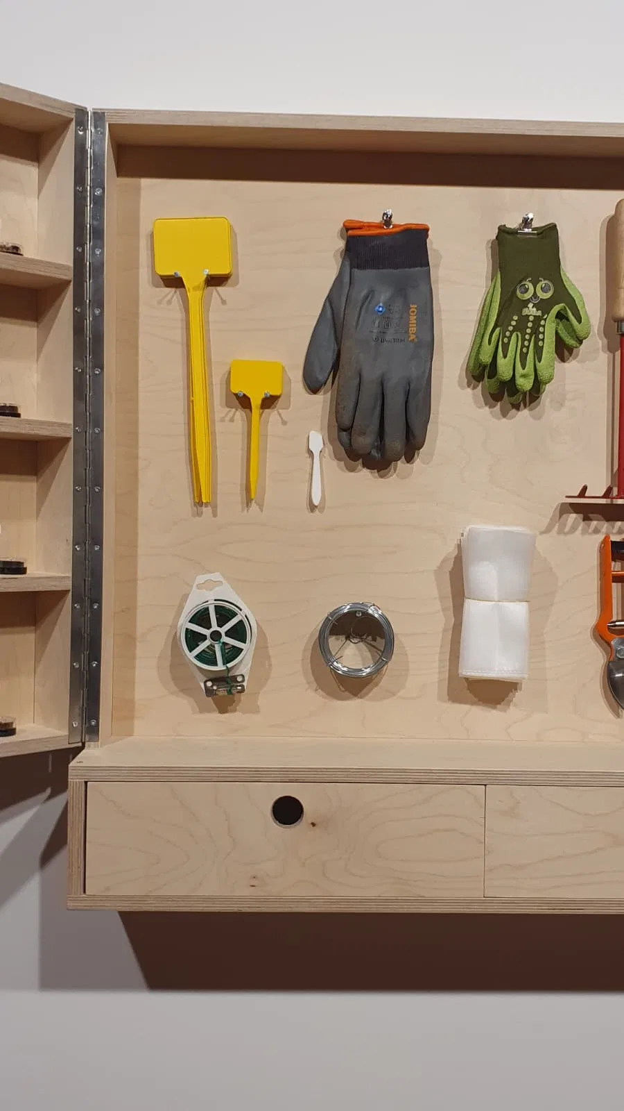 Working tools stored within the cabinet.