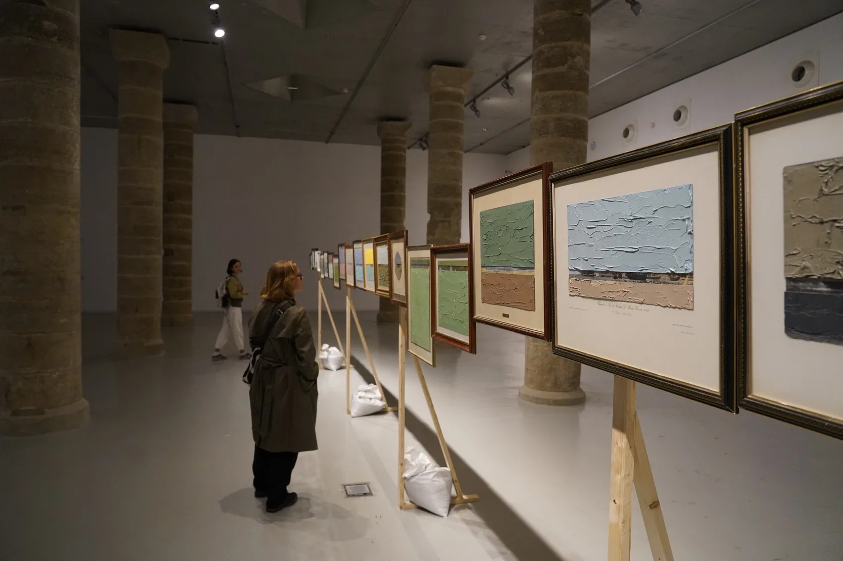 Framed works extend the cabin into the exhibition space.